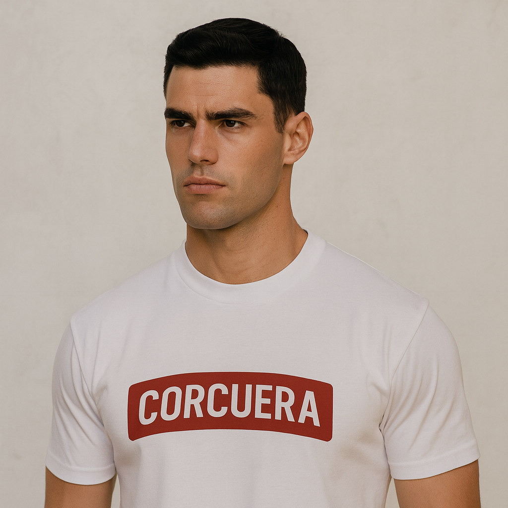 Man wearing a white t-shirt with 'CORCUERA' printed on it against a plain background